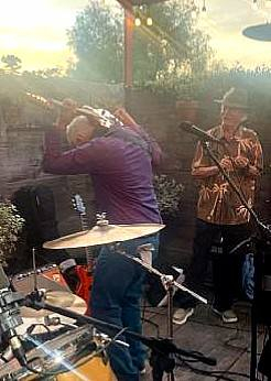 Band members performing with horn section